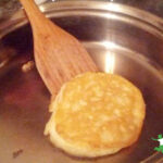 healthy rice cake in frying pan with bamboo spatula