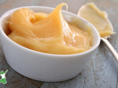 sugarfree, fruit sweetened lemon curd in a small white bowl with spoon