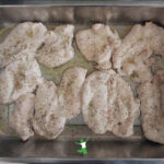 lemon pepper chicken cutlets in baking pan