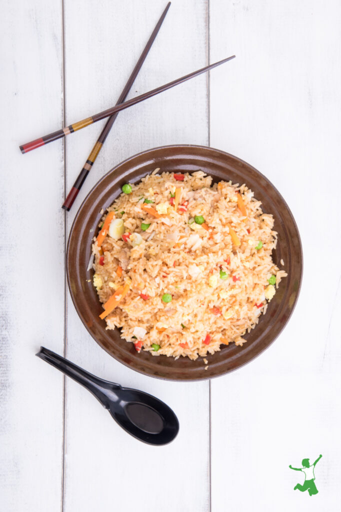 healthy fried rice with chopsticks in brown bowl