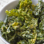 homemade crunchy kale chips in white bowl