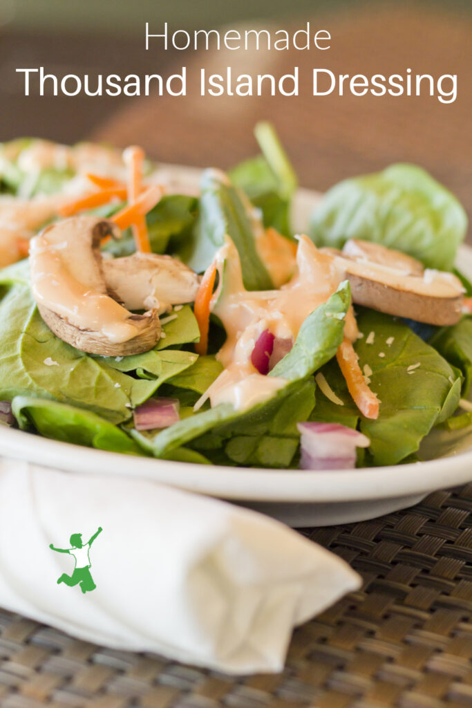 probiotic Thousand Island dressing in white bowl with salad greens