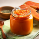 probiotic papaya butter in glass jar with wooden spoon