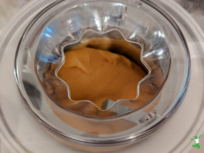 churning homemade cultured mango sorbet