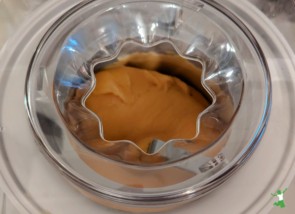 churning homemade cultured mango sorbet