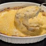 garlic au gratin potatoes in white casserole dish