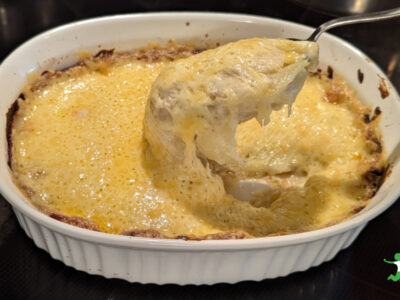 garlic au gratin potatoes in white casserole dish