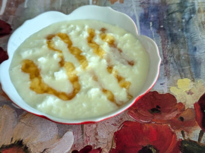 raw L. reuteri yogurt with a drizzle of honey in red dish