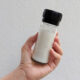 unrefined white sea salt in a glass grinder