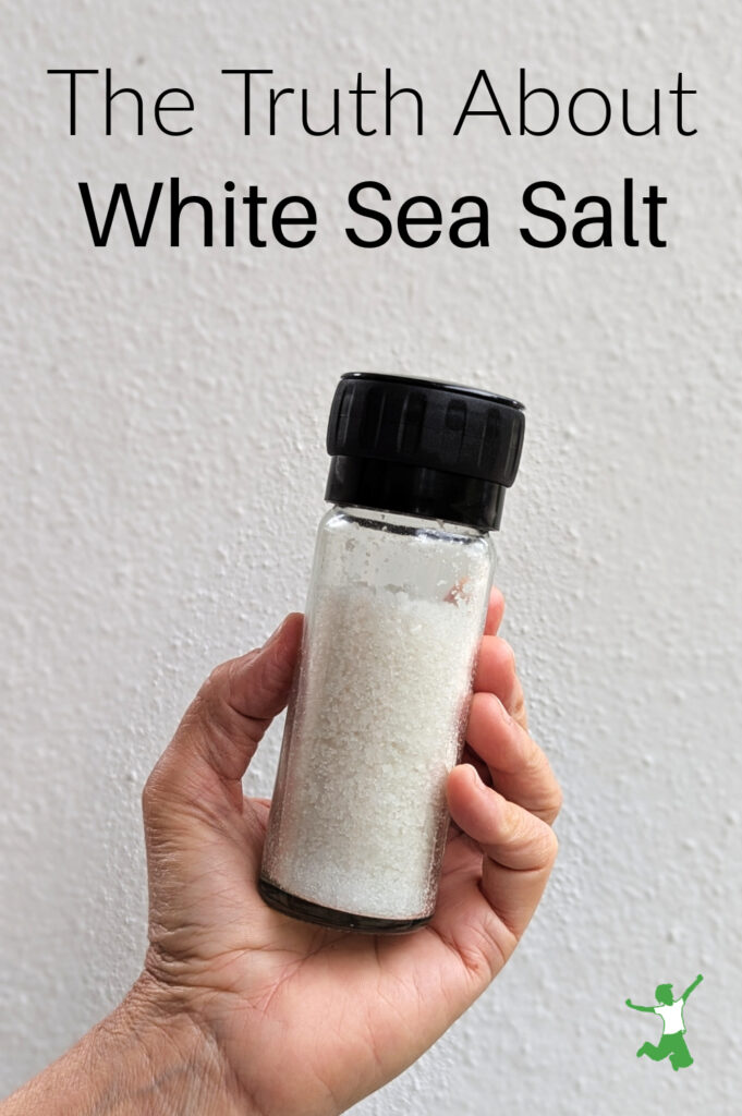 coarse white sea salt in glass bottle