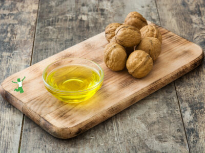 walnut oil in small glass dish on cutting board