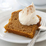 healthy slice of pumpkin bread with whipped cream on a plate