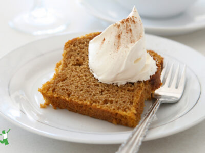 healthy slice of pumpkin bread with whipped cream on a plate