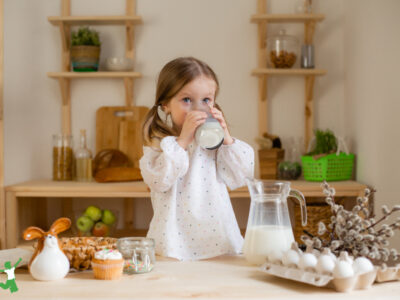 little girl drinking glass of raw grassfed milk