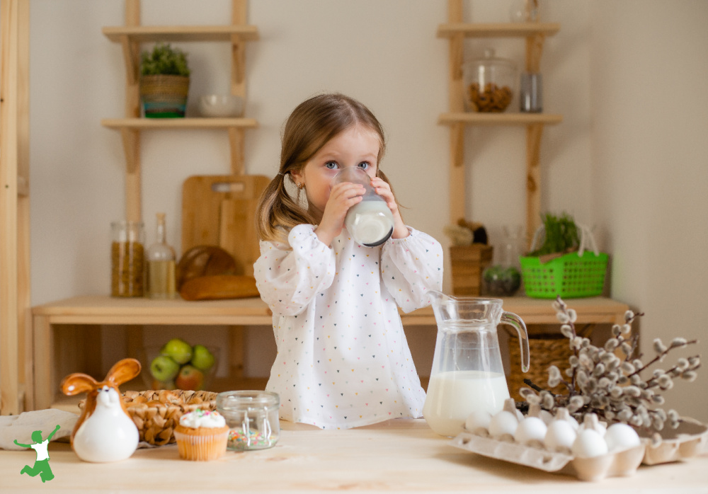 young girl drinking glass of raw milk