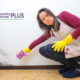 woman cleaning mold from her kitchen walls