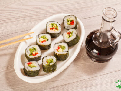 healthy soy sauce substitute in glass bottle with sushi