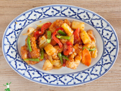 healthy sweet & sour sauce with chicken and vegetables on dinner plate